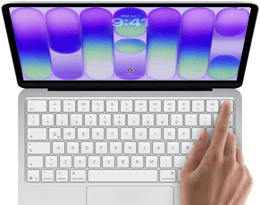 MacBook Neo, color plata, muestra la pantalla de inicio de sesión, el dedo de una persona en el sensor de Touch ID en la esquina superior derecha del teclado